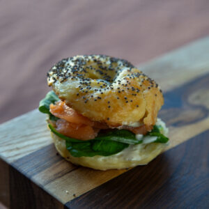 Bagel de salmón gravlax, rucula, palta
